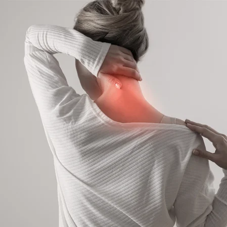 A woman holding her neck in pain